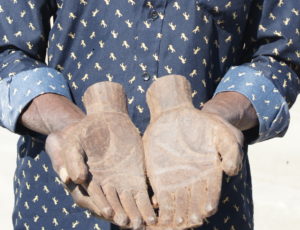 Lozi carver holding a sculpture of his own hands - Zambezi